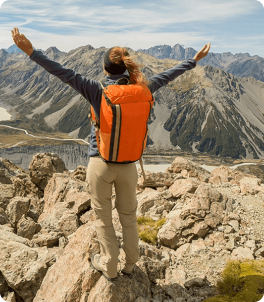 Traveler celebrating at a mountain viewpoint